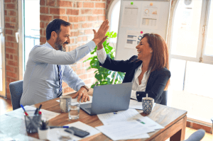 Image of business man and woman doing a high 5 for Quiet Quitting Blog